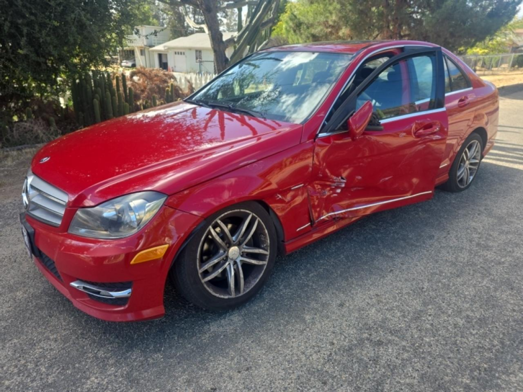 Red Mercedes Benz damaged door